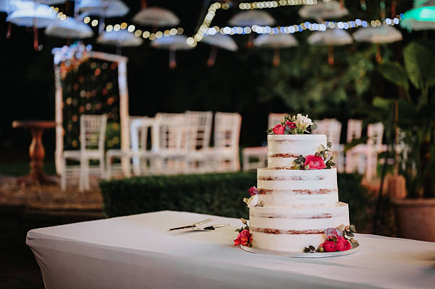 istock Beautiful naked wedding cake with flower decoration. 2228517992