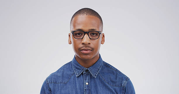 istock Black man, portrait and student with glasses in studio for optometry on a white background. Male person, nerd or geek model with spectacles or lens for style, eyesight or accessory on mockup space 2228518401