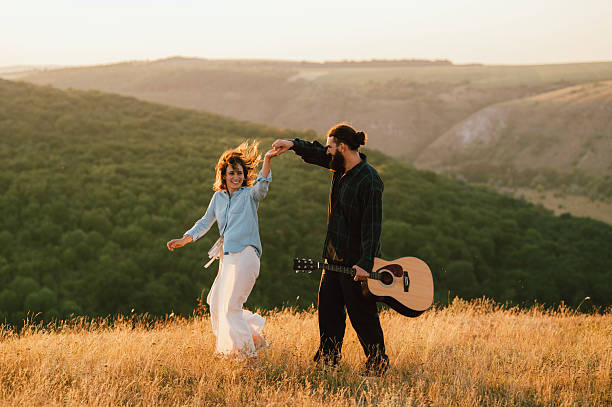 Experience the Joyful Outdoor Dance with a Guitar Set Amidst Natures Beauty and Serenity stock photo