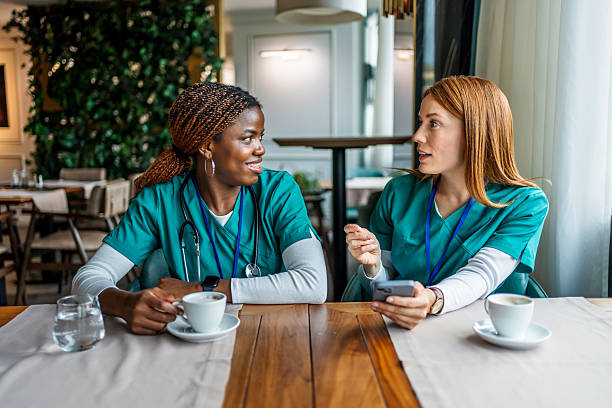 istock Two nurses enjoying coffee break and talking in restaurant 2228518701