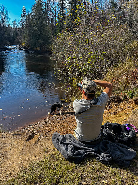 A Photographer Captures a Dog by the River