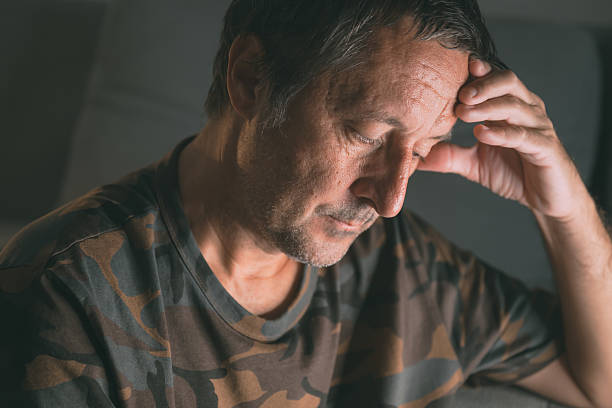 istock Stressed mature man with hand on forehead sitting indoors, dealing with anxiety or burnout 2228519027