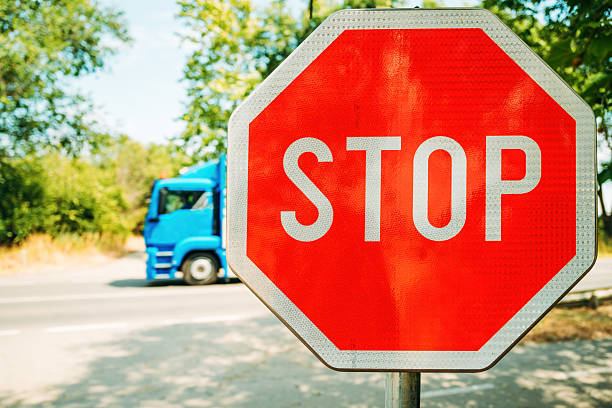 an Octagon city stop sign with cross street avenue