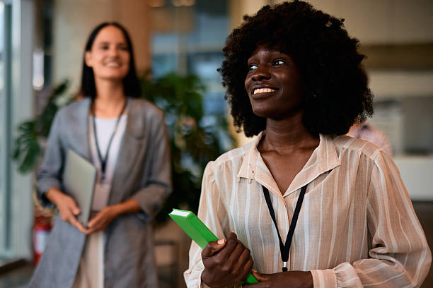 istock Young businesswomen attending a conference smiling and holding a notebook 2228519463
