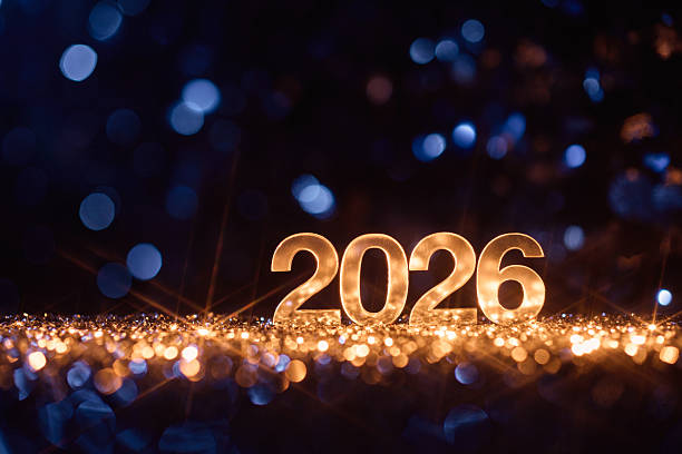 istock Golden Numbers 2026 Glowing Amid Sparkling Lights and Blue Bokeh Background 2228519603