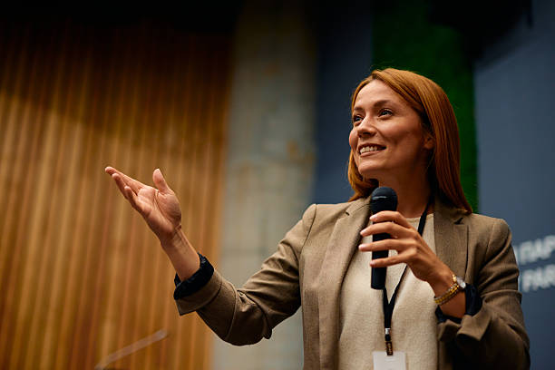 istock Motivational speaker inspiring audience during corporate seminar 2228519676