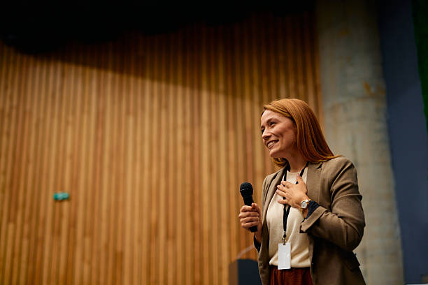 istock Motivational speaker inspiring audience with her speech during a business seminar 2228519682