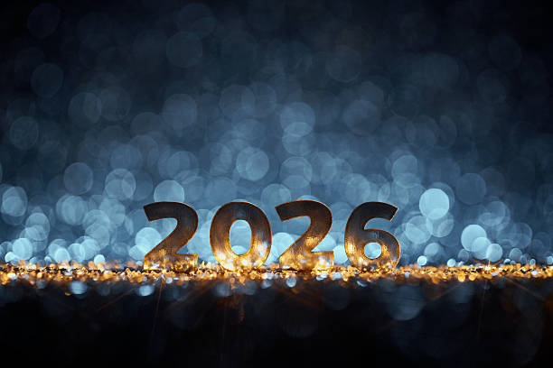 istock Golden 2026 Numbers on Glittering Surface with Glowing Blue Bokeh Lights 2228519723