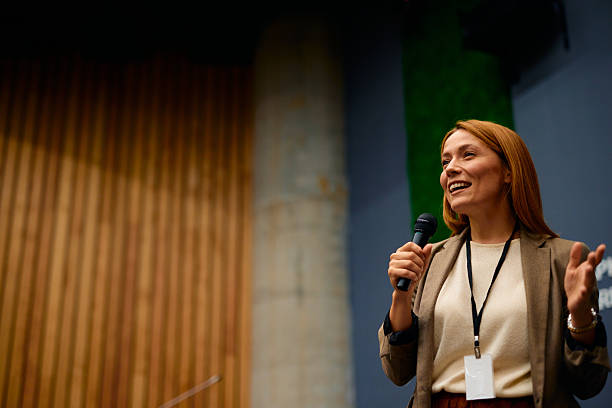 istock Confident speaker inspiring audience at business conference 2228519753