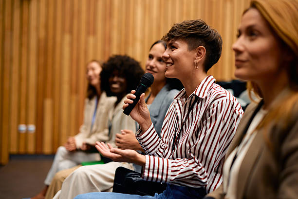 istock Businesswoman speaking at a conference using a microphone 2228519783