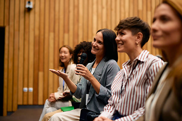istock Businesswoman speaking at a conference using a microphone 2228519789