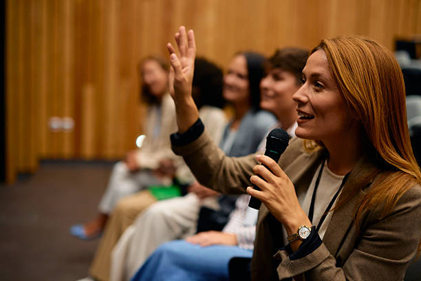 istock Motivational speaker answering questions during a business conference 2228519801
