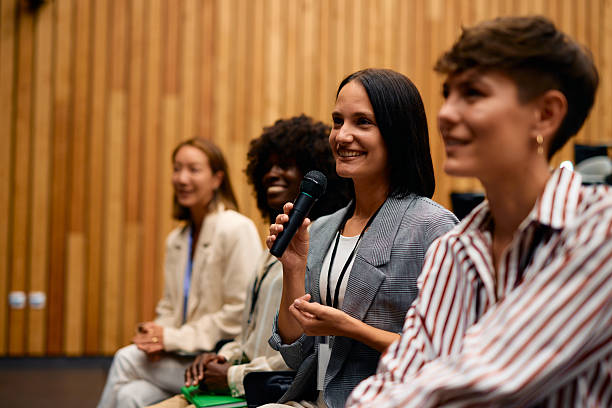 istock Businesswoman speaking at a conference using a microphone 2228519806
