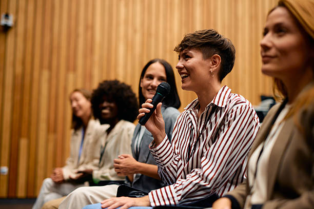 istock Businesswoman speaking at a conference using a microphone 2228519825