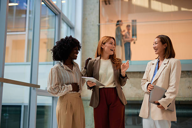 istock Businesswomen having a conversation in the office hallway 2228519968