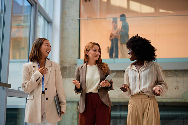 istock Businesswomen walking and talking in modern office building 2228519981