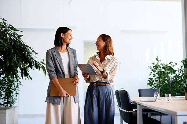 istock Two businesswomen discussing work in modern office 2228520216