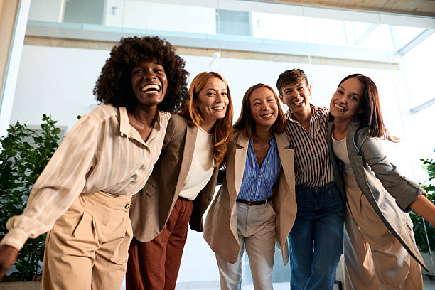istock Five businesswomen smiling and hugging in the office 2228520741