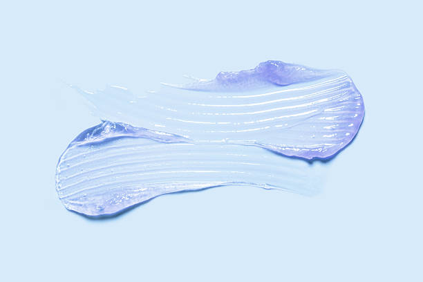 istock Lip balm purple lilac mask colored texture swatch smudge on blue background 2228521204