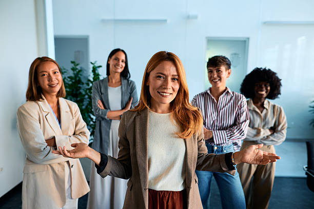 istock Five businesswomen smiling and posing in their modern office 2228521766
