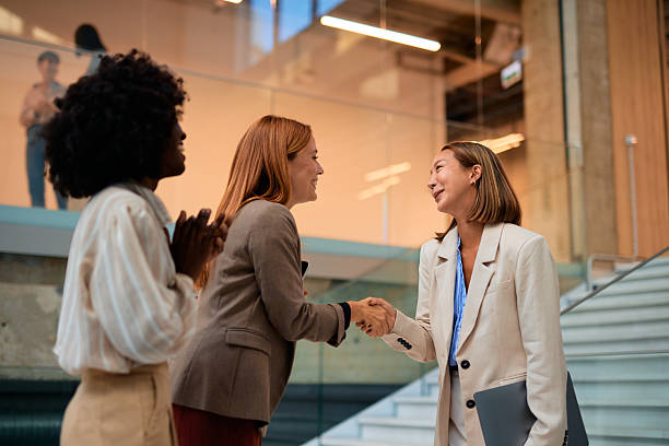istock Businesswomen shaking hands in modern office lobby 2228521870