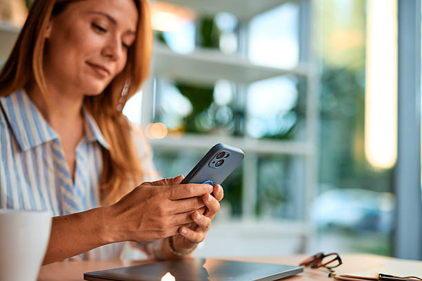 istock Businesswoman using smartphone in modern office 2228522314