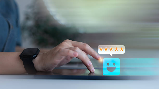 istock Close-up hand tapping on tablet with smiley face and five-star feedback icon, representing customer review, user experience, satisfaction rating, and digital reputation. 2228525690