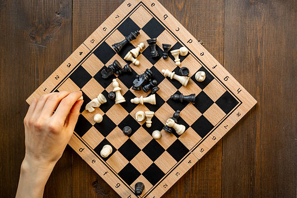 istock Hand is holding chess piece on chessboard. Game concept 2228527349