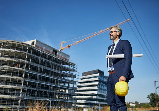 istock senior businessman architect helmet construction site building architecture tablet computer protective workwear blueprint plan 2228530348