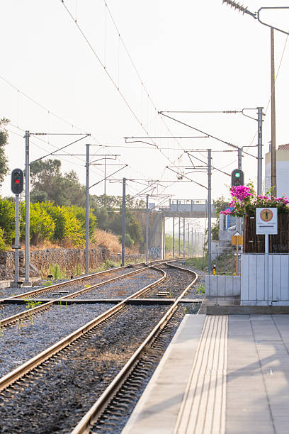 istock Sunlit railway tracks with overhead lines 2228530693