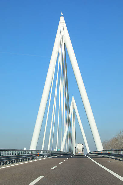 Badia Polesine, RO, Italy - March 5, 2025: \n cable-stayed bridge in the freeway A31 with big white pylons with a truck
