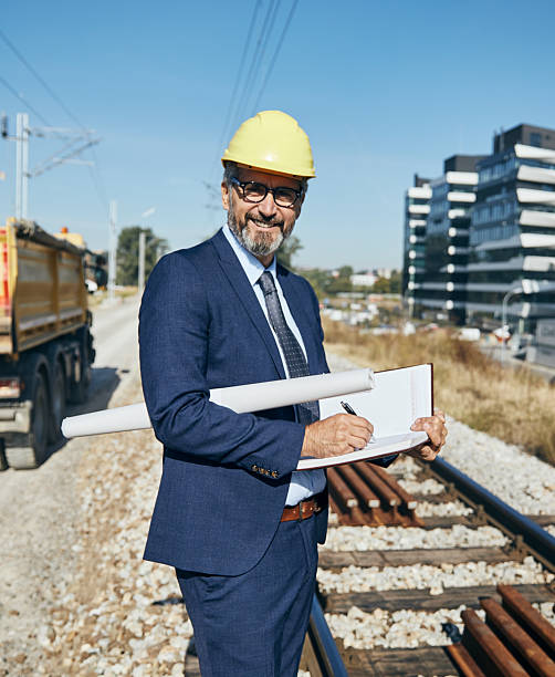 istock senior businessman architect helmet construction site building architecture writing notebook protective workwear blueprint plan 2228530999
