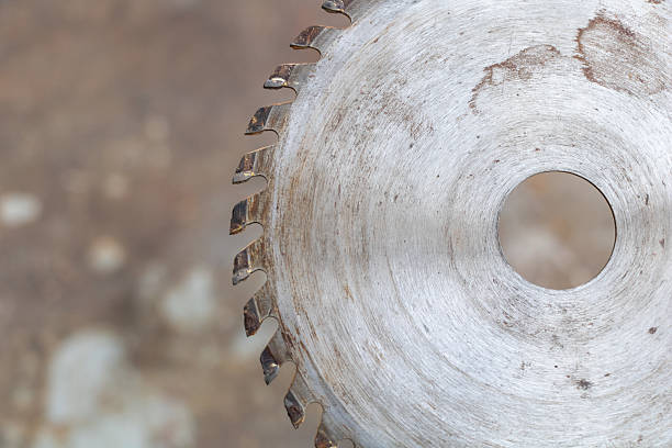 Detailed view of a power grinding tool, focusing on texture and craftsmanship, situated in a workshop loaded with tools and equipment. Ideal for topics on industry, craftsmanship, or mechanical tools.