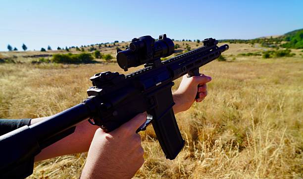 istock Person holding a machine gun in his hand 2228533029
