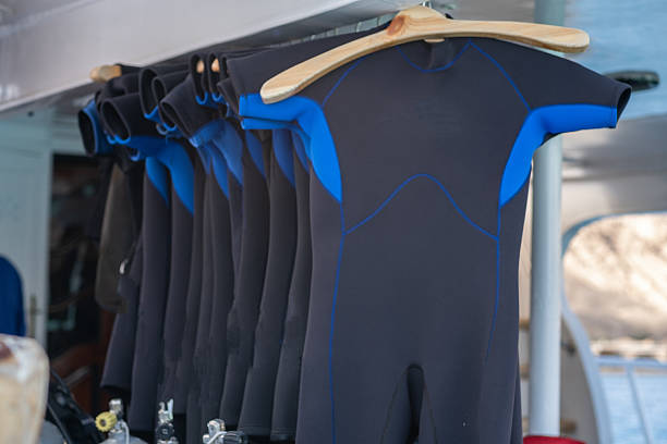 Wetsuits Hanging on Display for Diving Activities at a Marine Location During Sunny Weather