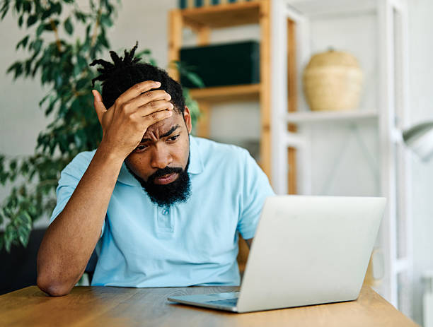 istock man computer laptop bill finance problem debt worried sad tax paper budget document unhappy payment paying money calculating business 2228533665