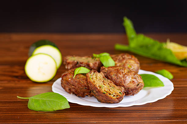 istock Portioned vegetable muffins with herbs on a dark wooden table 2228533789