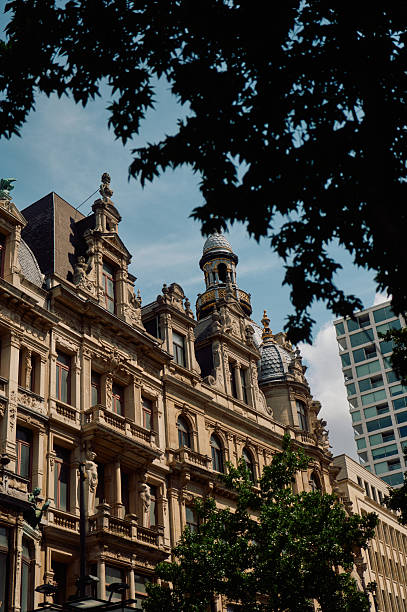 Ornate facade of a historic building with domes and decorative elements, located in antwerp, belgium, showcasing the city's architectural heritage