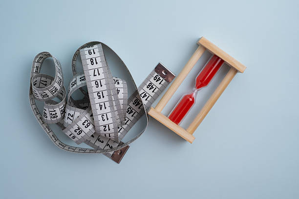 istock Measuring tape, watch and pills, vitamins on a light background with space for text. Concept of losing weight, diet, fat burning, healthy eating. Time to drink vitamins and pills 2228536677