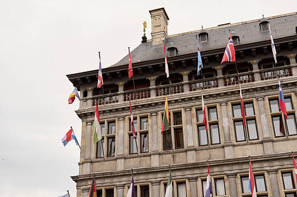 Flags of the world waving on a building, symbolizing international cooperation and unity