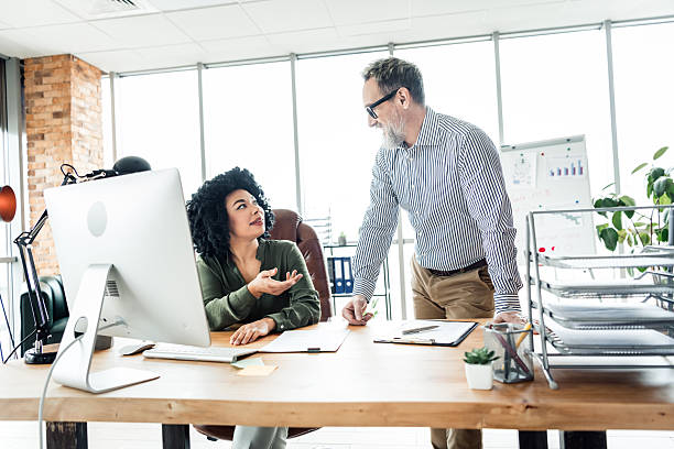 istock Modern office setting showcasing coworker collaboration with emphasis on teamwork, mentoring, and professional development 2228538404