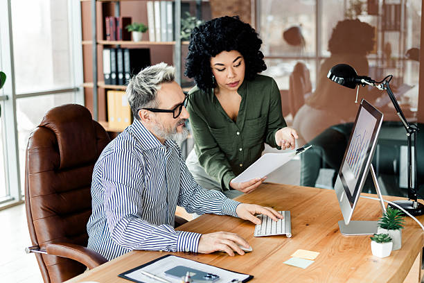 istock Professional teamwork collaboration in a modern workplace with diverse colleagues reviewing documents and strategies 2228538490