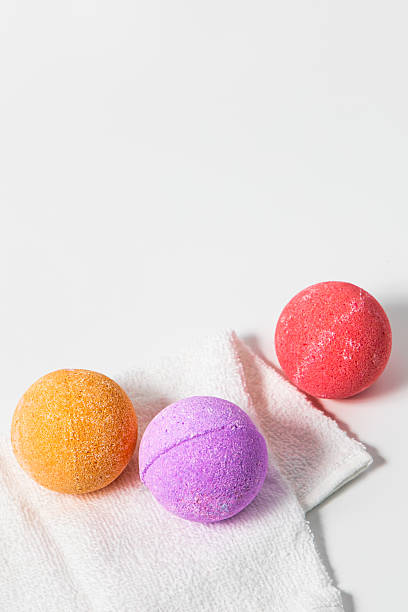 istock Colorful bath bombs on white towel ready for a relaxing spa experience at home 2228540595