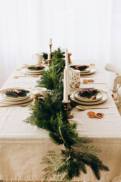 istock Elegant dining table decoration with greenery and candles for a festive gathering 2228541150