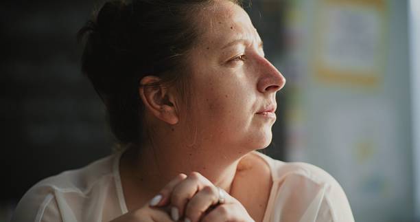 istock Exhausted Female Teacher Taking Off Glasses, Sitting Alone in Empty Classroom, Feeling Stress 2228542460