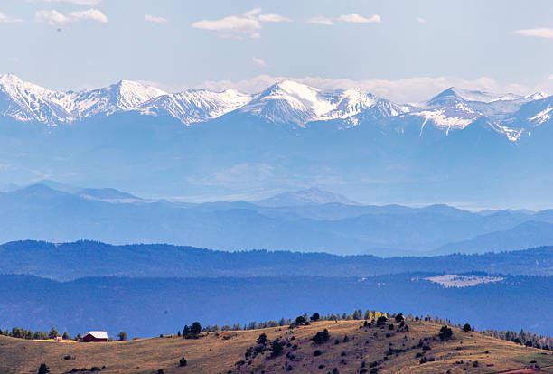Giant mountains in the background of a house