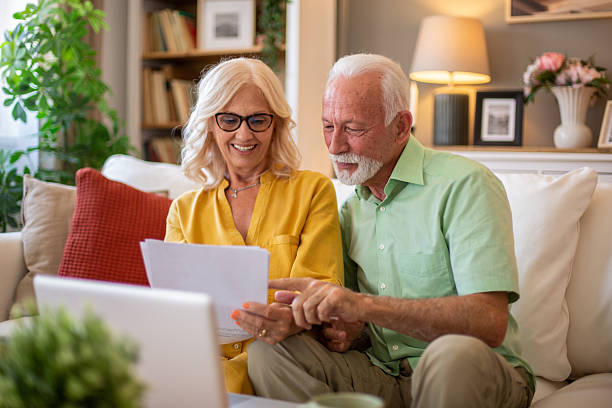 istock Senior couple managing finances and bills at home using laptop 2228543445