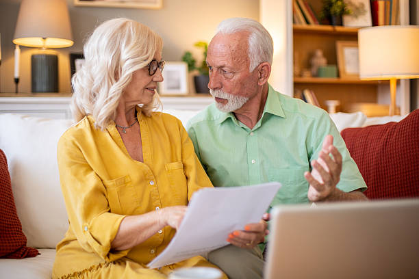 istock Senior couple reading documents and discussing about home finances 2228543457