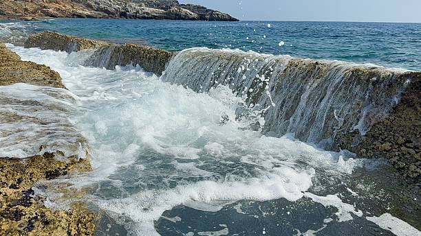 istock Waves splashing through stone plates on Koru Beach, Alanya 2228545238