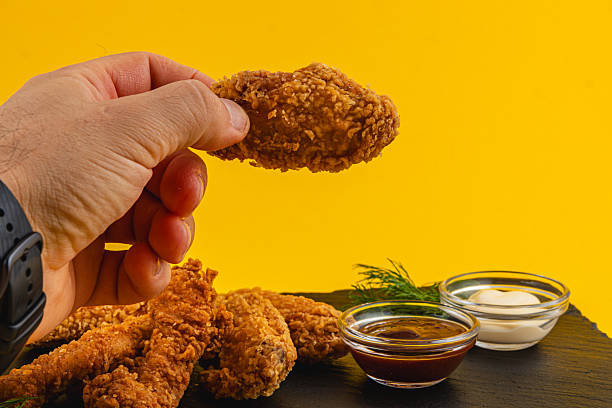 istock Crispy chicken wings with sauces on a yellow background 2228545550